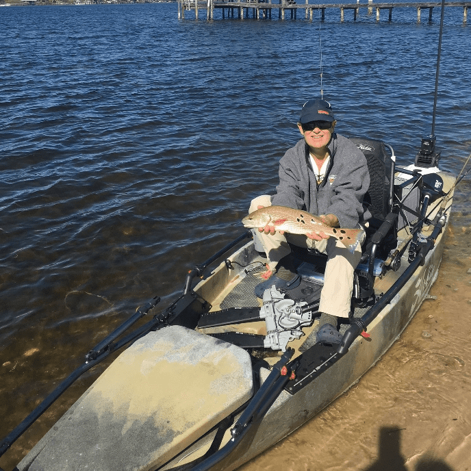 fred garth holding a fish on boat community